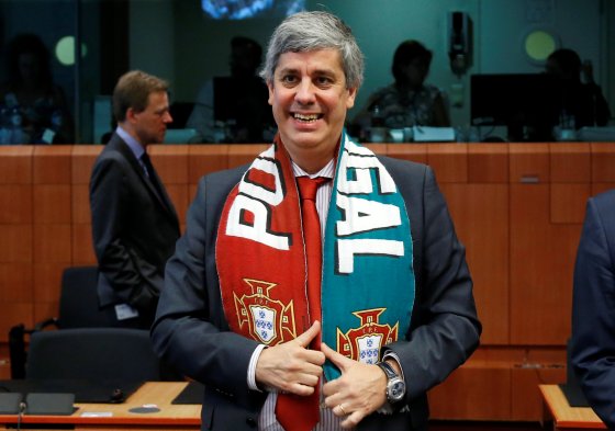 Portugal's Finance Minister Centeno poses with a national scarf during an euro zone finance ministers meeting in Brussels